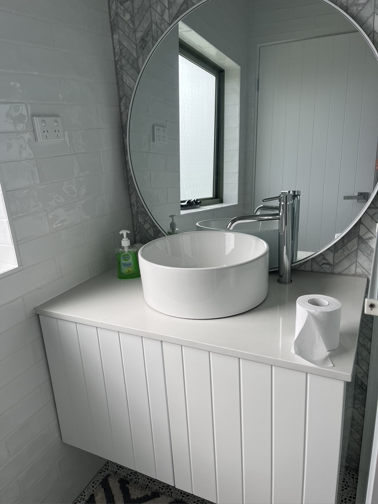 Bathroom vanity and tiled finishes at the Copacabana renovation by Halo Building Projects