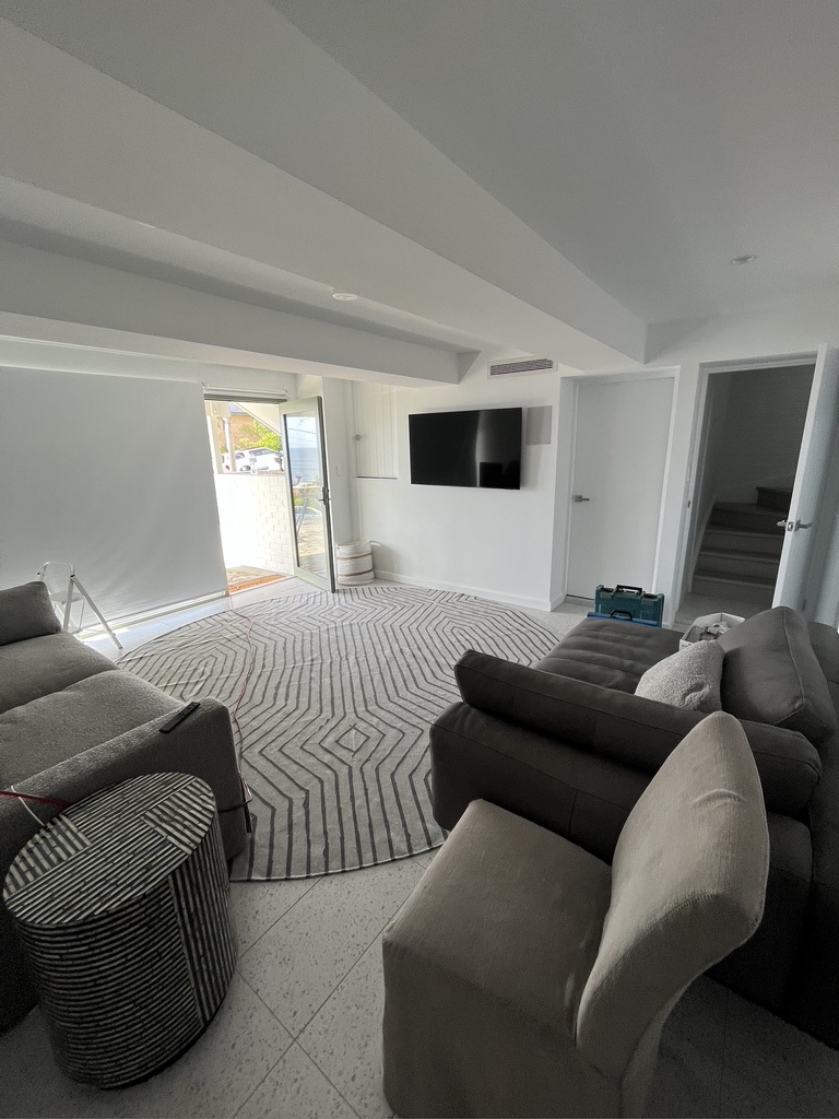 Renovated living space at the Copacabana renovation by Halo Building Projects