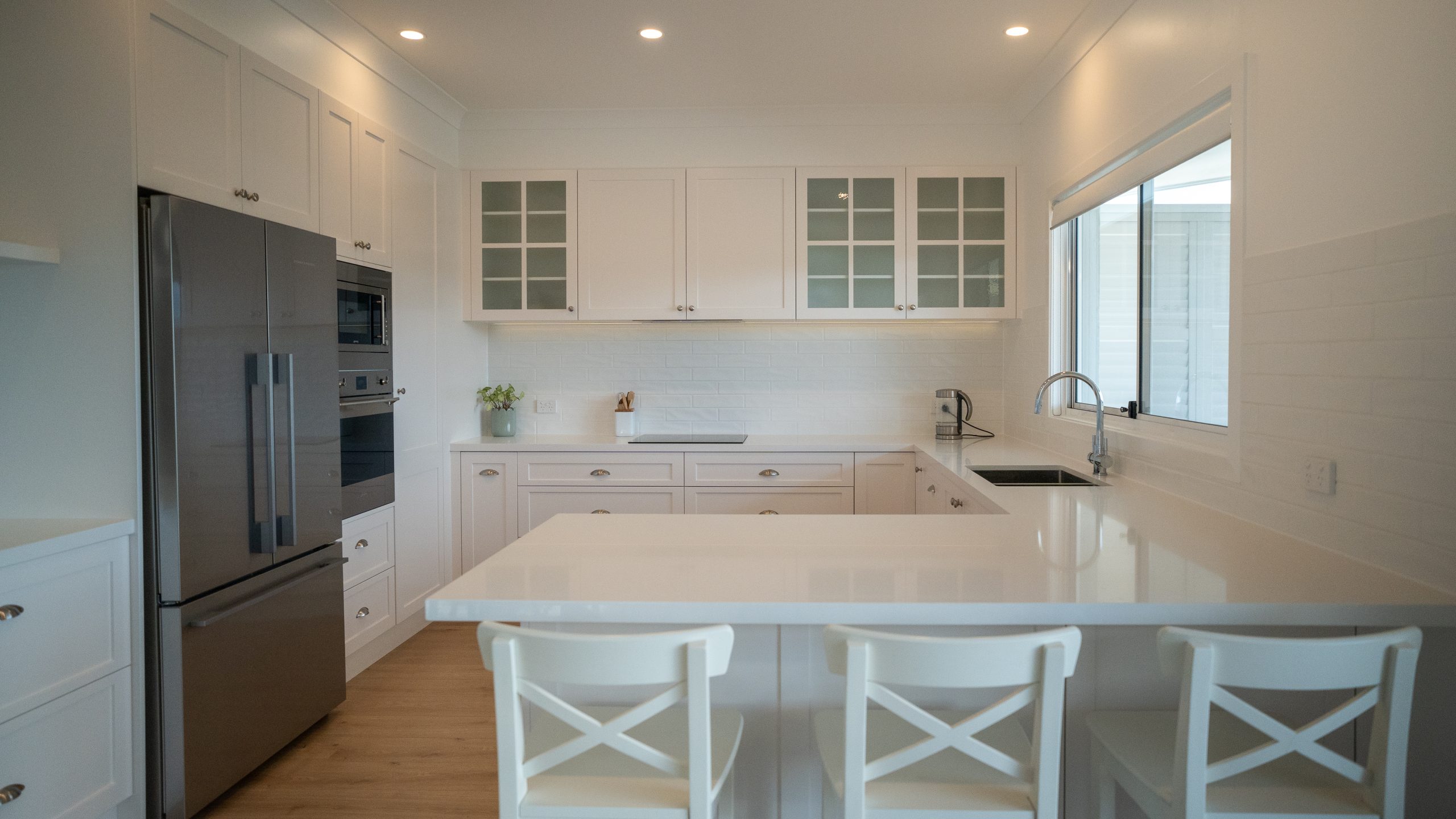 Reconfigured kitchen with Caesarstone benchtops at the Davistown renovation by Halo Building Projects