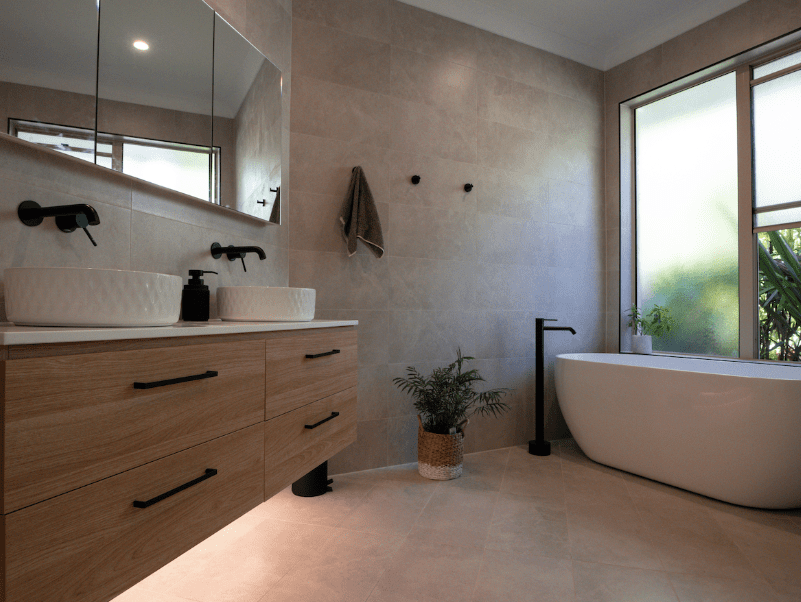 Modern bathroom with timber double vanity, freestanding bath and black tapware